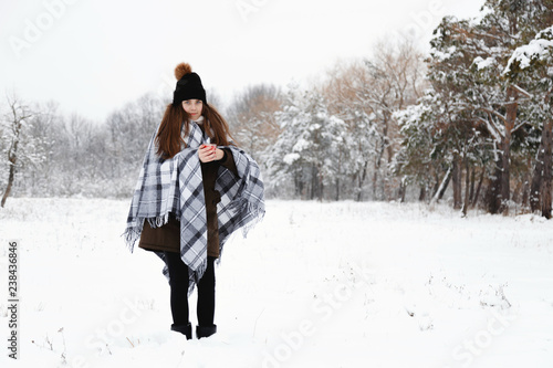 Portrait of a girl in the winter with a candle