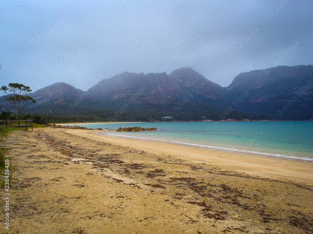 A lonely beach in Tasmania near the mountains