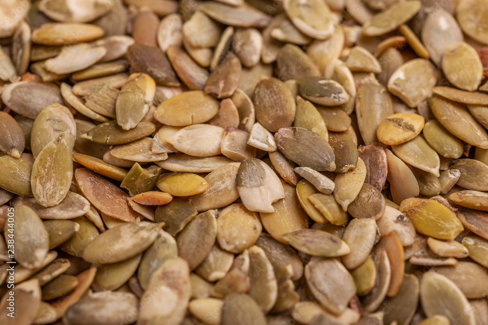 Heap of fresh pumpkin seeds background. Close up Heap of fresh pumpkin seeds background. Close up