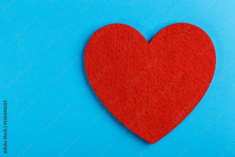 Red felt heart on bright blue background. St. Valentine's day Red felt heart on bright blue background. St. Valentine's day