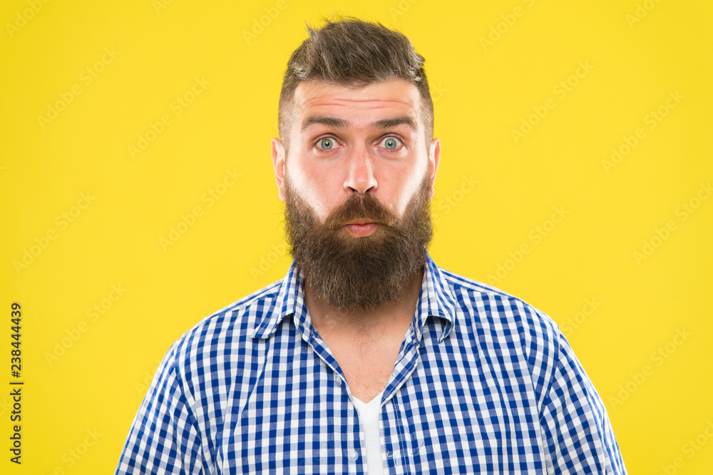 Obraz premium Burst of laughter. Hipster with beard and mustache emotional surprised expression. Rustic surprised macho. Man bearded hipster wondering face yellow background close up. Guy surprised face expression