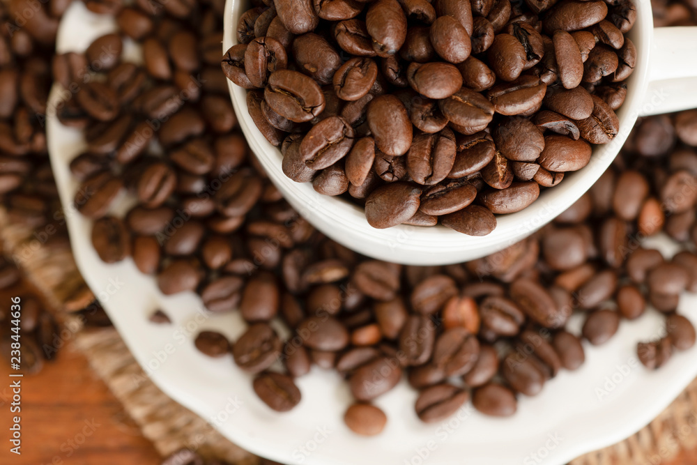 Coffee beans in cup and saucer Coffee beans in cup and saucer