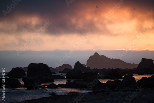 sunset on beach with sea stacks