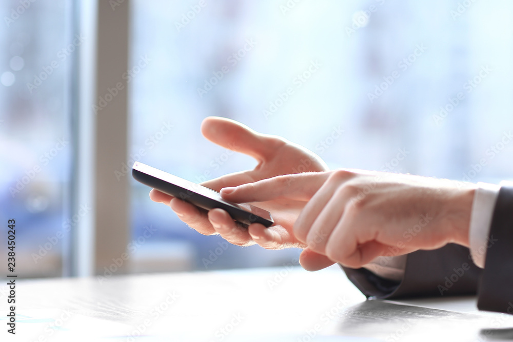 close up.modern man typing text on a smartphone close up.modern man typing text on a smartphone