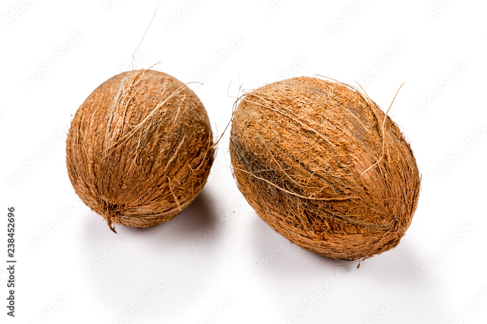 Two raw coconuts isolated on white background Two raw coconuts isolated on white background
