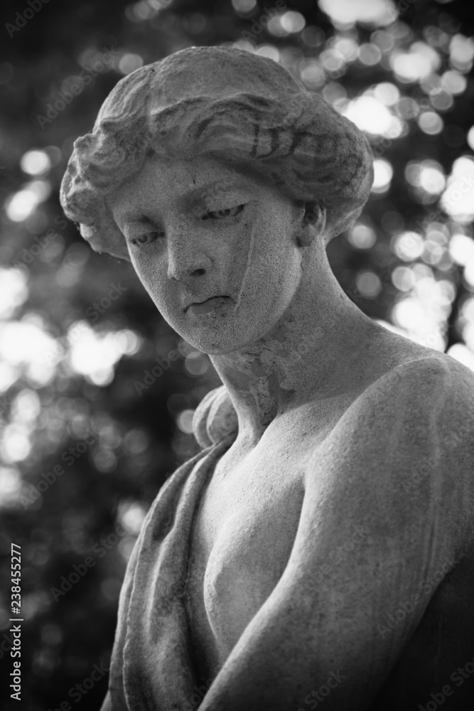 The goddess of love in Greek mythology, Aphrodite (Venus in Roman mythology) Fragment of ancient statue. Black and white photo.
