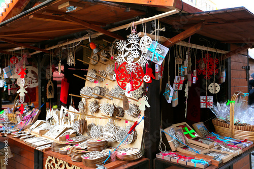 Beautiful wooden multi-colored Christmas toys for decorating house at Christmas Market. Xmas market in Europe on holidays