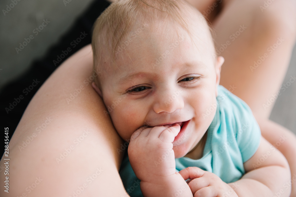 Smiling baby boy with his hand in his mouth Smiling baby boy with his hand in his mouth