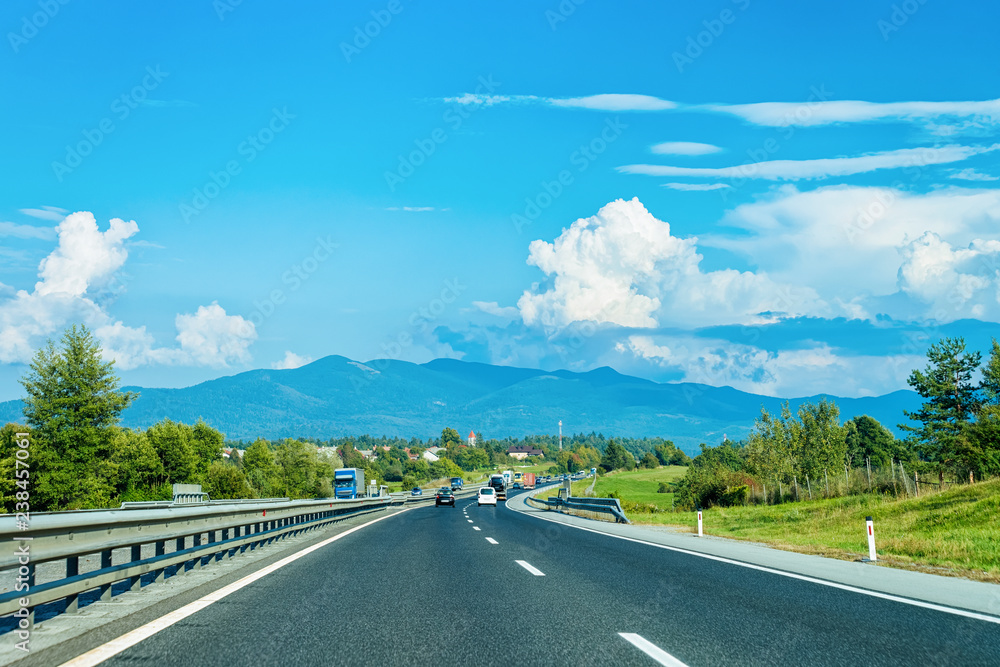 Scenic landscape with cars on road at Slovenia Julian Alps Scenic landscape with cars on road at Slovenia Julian Alps
