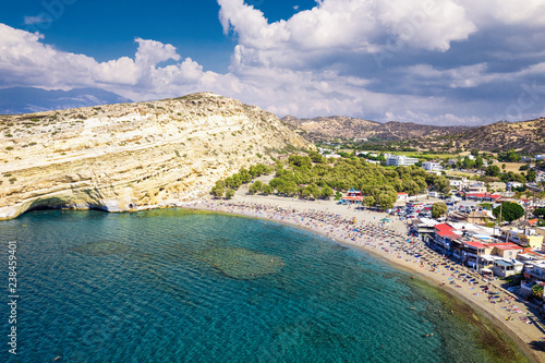 Fototapeta Naklejka Na Ścianę i Meble -  Aerial view of Matala beach on Crete island with azure clear water, Greece, Europe