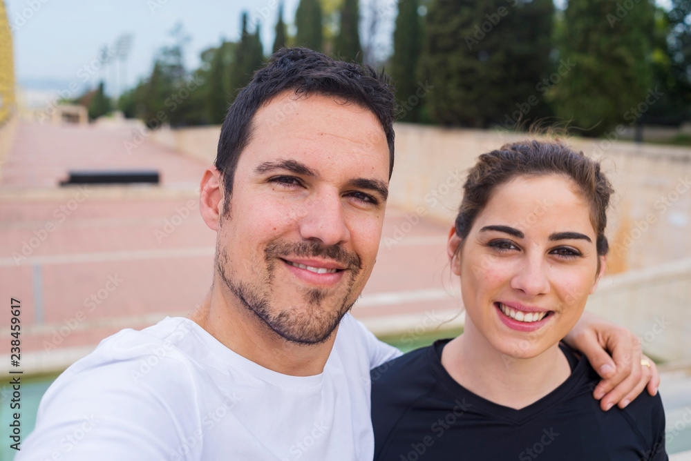 Portrait of smiling couple standing at park Portrait of smiling couple standing at park