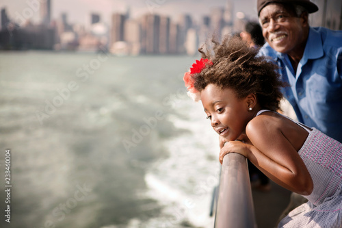 Smiling girl with grandfather travelling in ferry photo