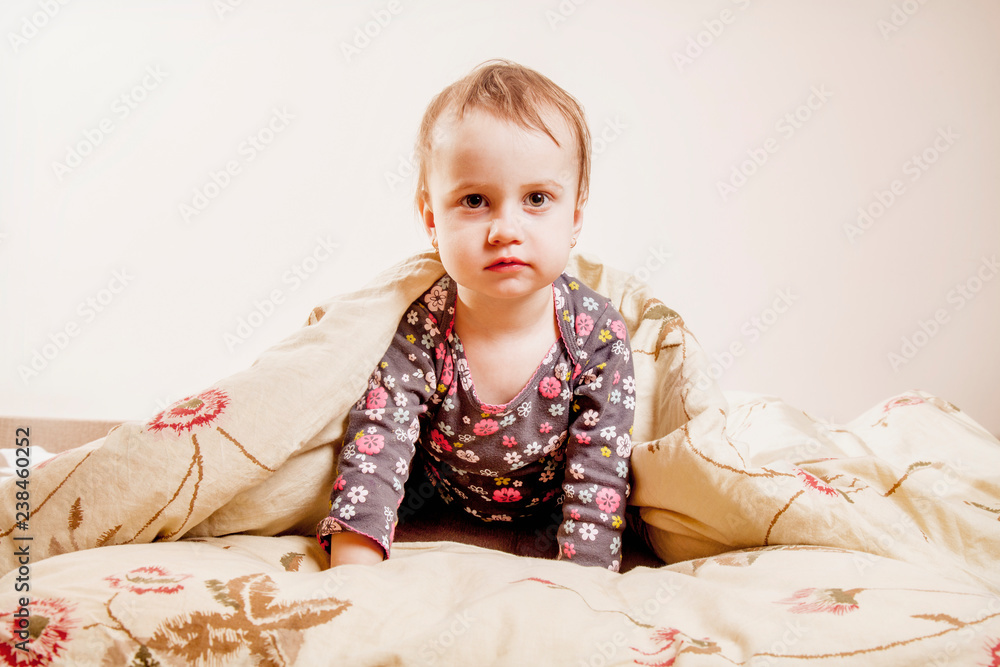 Funny cute active little child girl doesn't want going to fall asleep. Happy carefree childhood, family and rest concept. Funny cute active little child girl doesn't want going to fall asleep. Happy carefree childhood, family and rest concept.