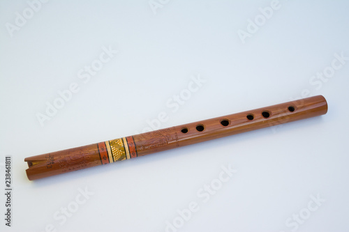 Old Quena of Peru (traditional flute of the Andes), with 37 notes and three octaves, 37 cm long. It consists of a tube with a simple notch, has six front holes, one back. Isolated on white background.