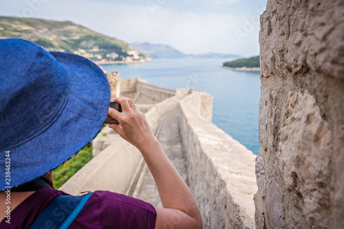 Female tourist taking pictures of Dubrovnik