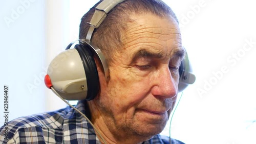 Hearing test. Man with headsets listen to a noise. Occupational health and safety for audiometric testing photo