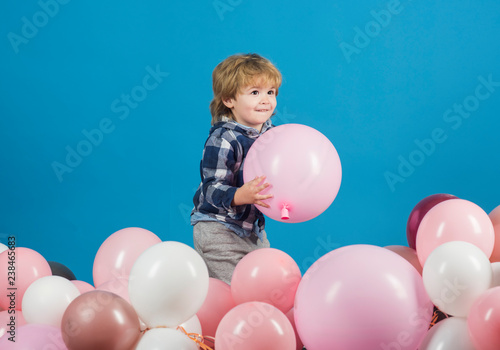 Children background. Happy child on a blue background. Smile on the face of a little boy. Cute kid. Children's advertising. Handsome happy toddler © Tverdokhlib