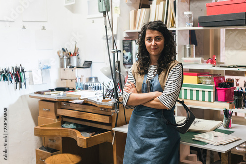 Portrait of smiling artisan standing in workshop photo