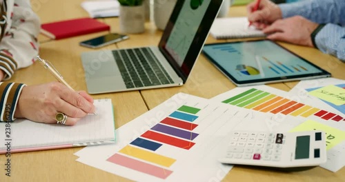 Business Colleagues Checking Over Financial Data In Their Office