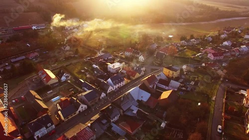 Camera flight over a Czech village in winter. Local heating is important source of emissions. Air pollution and climate change theme. Sustainable development and ecology in European Union.