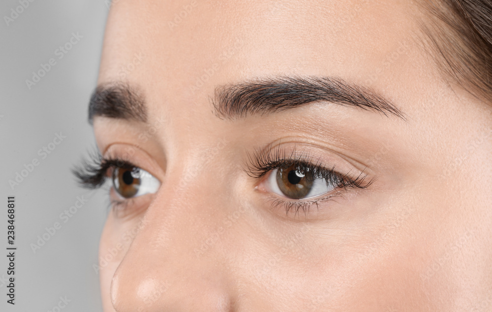 Naklejka premium Young woman with beautiful eyelashes, closeup view
