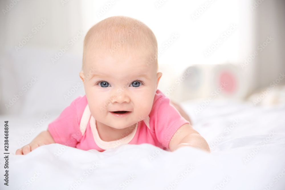 Pretty baby lying on bed at home, closeup Pretty baby lying on bed at home, closeup
