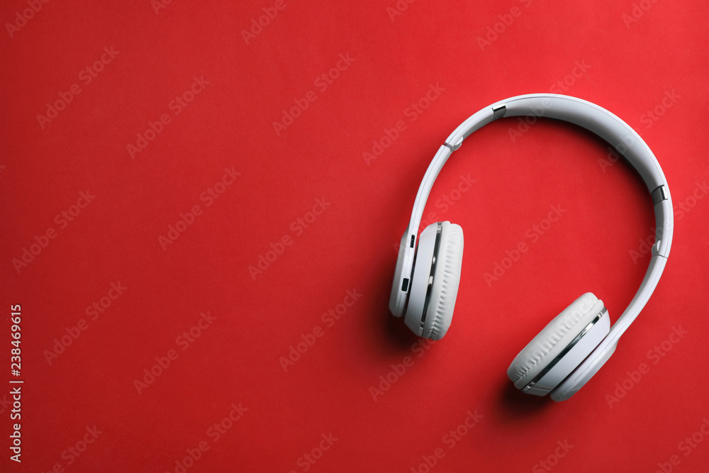 Wireless headphones on color background, top view. Space for text Wireless headphones on color background, top view. Space for text