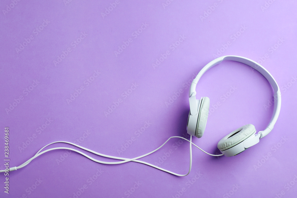 Stylish headphones on color background, top view. Space for text Stylish headphones on color background, top view. Space for text