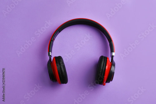 Wireless headphones on color background, top view