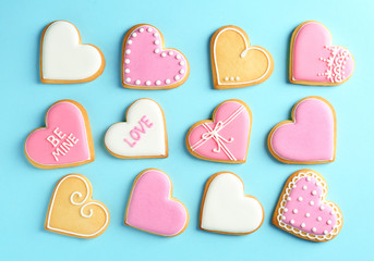Decorated heart shaped cookies on color background, top view. Valentine's day treat
