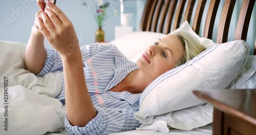 Beautiful Blond Woman Checking Her Smart Phone After Waking Up