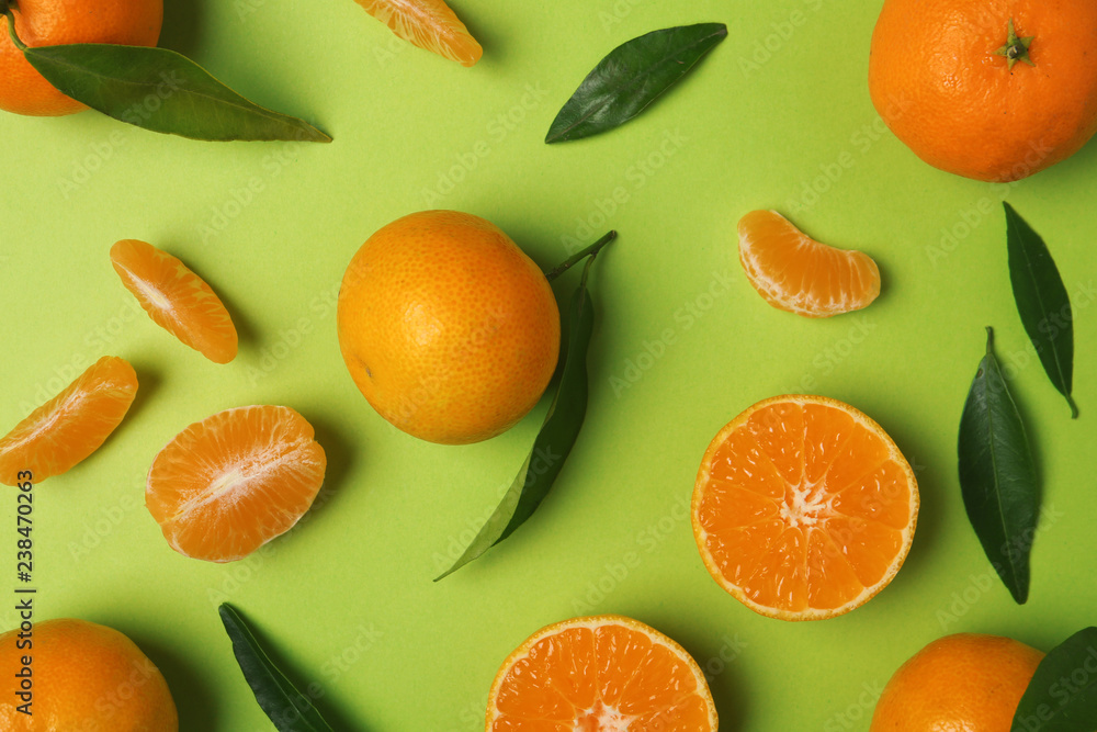 Composition with tangerines and leaves on color background, flat lay Composition with tangerines and leaves on color background, flat lay