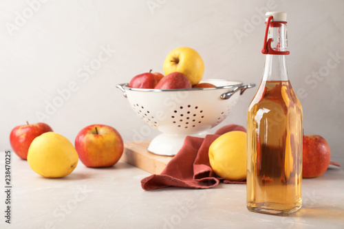 Fototapeta Naklejka Na Ścianę i Meble -  Composition with bottle of apple vinegar on table. Space for text