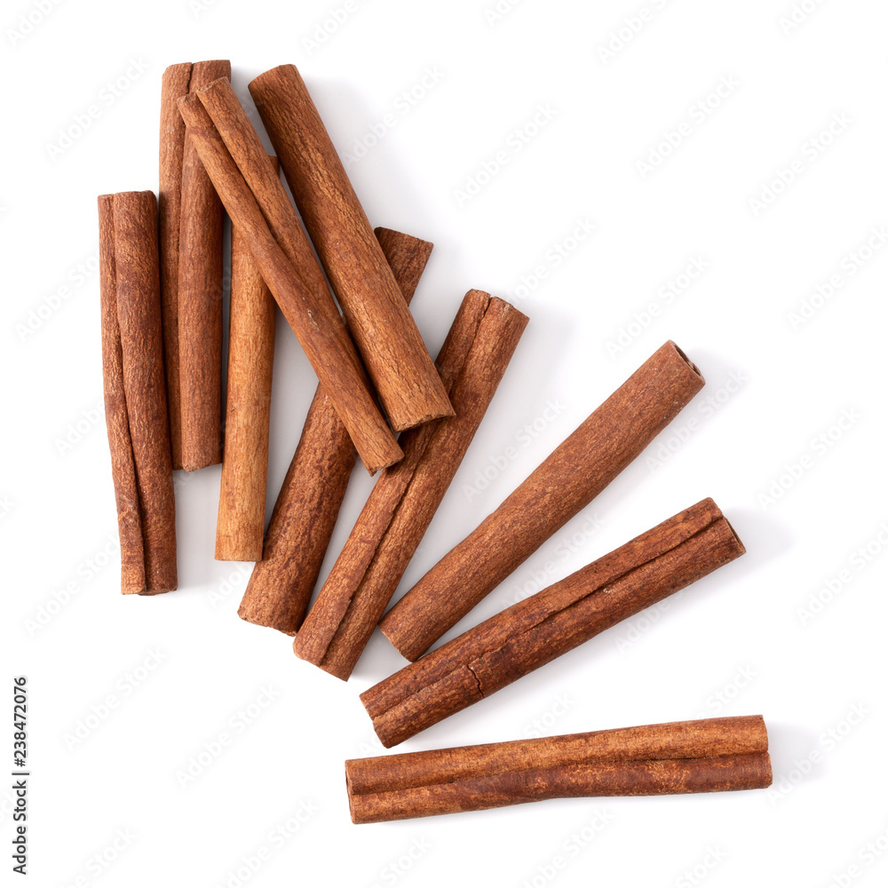 Cinnamon sticks isolated on white background closeup. Canella spice. Aromatic condiment background. Flat lay, top view.