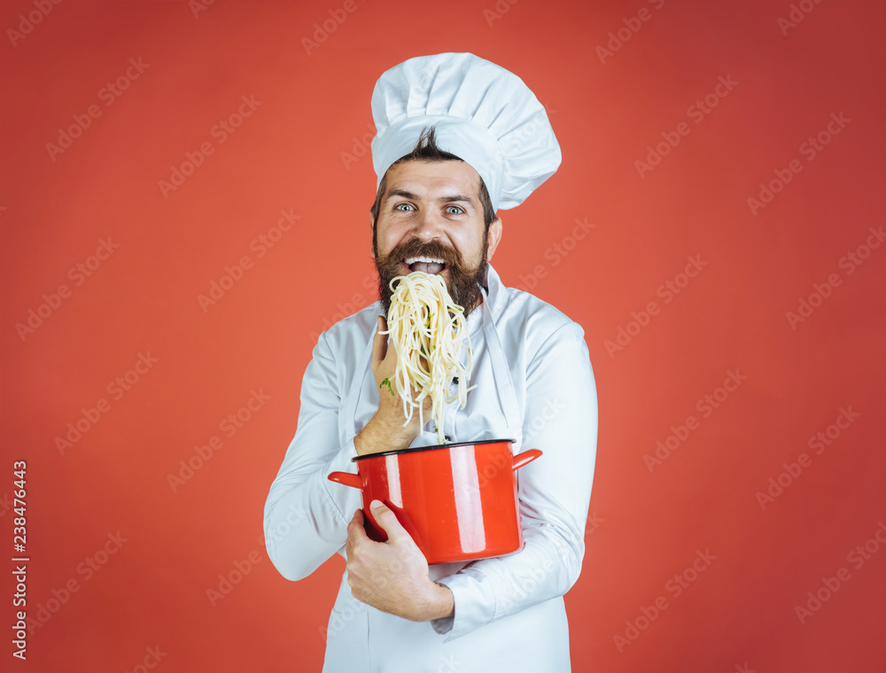 Spaghetti. Happy chef with pasta in hand. Chef eating delicious