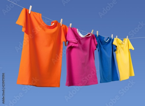 Wash clothes on a rope with clothespins on background