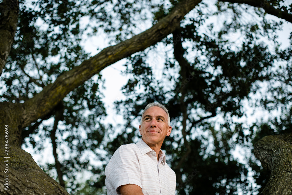 Thoughtful senior man sitting in park Thoughtful senior man sitting in park