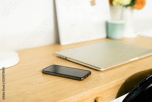 Wallpaper Mural High angle view of laptop computer with mobile phone on wooden desk in office Torontodigital.ca