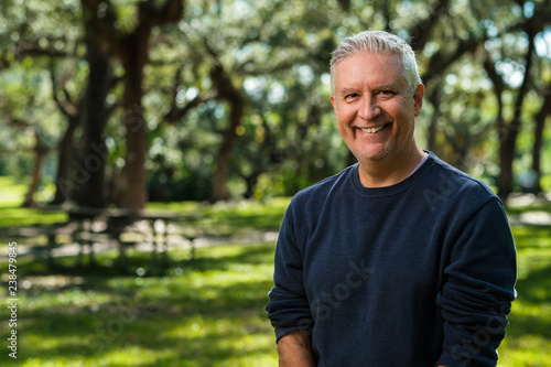 Handsome man outdoors in a park setting