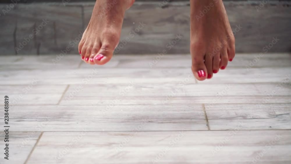 Legs woman with red nails jumping on floor rain falls beauty dance motion enjoy performance sensuality fun moving action pose active shoes art balance slow motion
