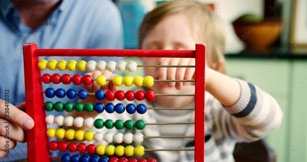 Father Teaching Son To Count Using Abacus