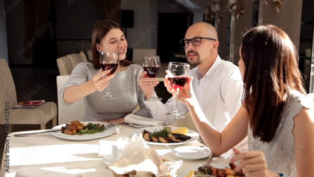 Friends have dinner in a restaurant and drink wine Friends have dinner in a restaurant and drink wine