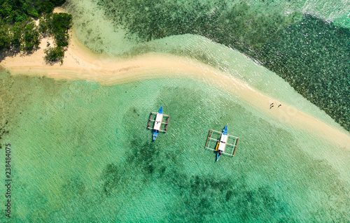 aerial view of traditional boats in a water near beach photo