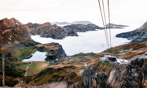 Stand and Rotair Ropeway Gondola station on cliff and alpine mountain valley of Titlis in Engelberg, Switzerland photo