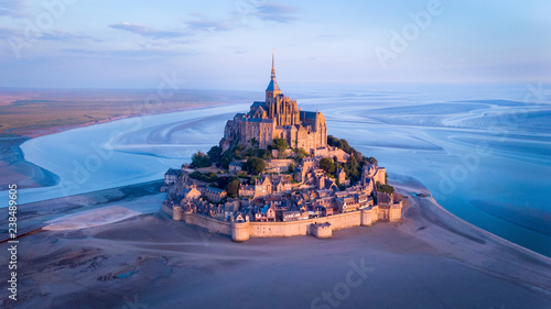 Aerial view of Mont Saint-Michel by river against sky during sunset photo