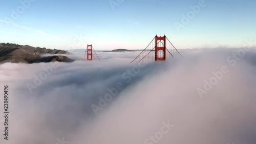 San Francisco Golden Gate Bridge Sticking / Poking Through Thick blanket of Fog - Aerial View / Flyover From Helicopter photo