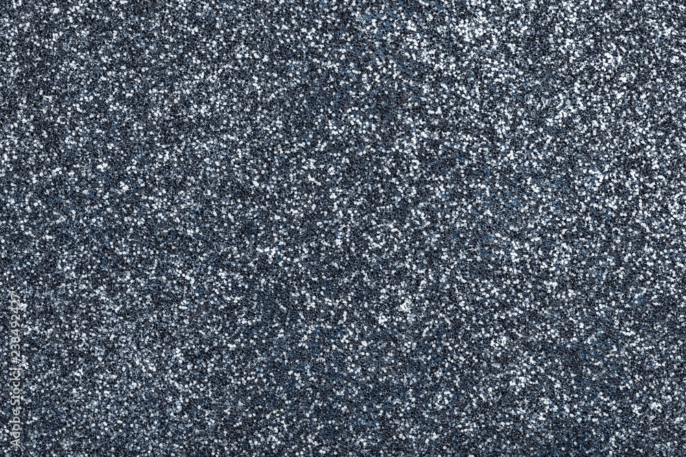 Dark gray sparkling background from small sequins, closeup. Brilliant backdrop.