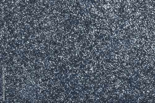 Dark gray sparkling background from small sequins, closeup. Brilliant backdrop.