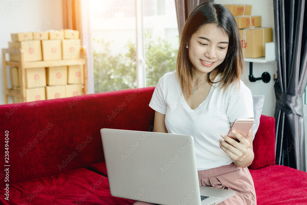 Young asian girl is freelancer with her private business at home office, working with laptop, coffee, online marketing, Customer order and packaging or packing. Young asian girl is freelancer with her private business at home office, working with laptop, coffee, online marketing, Customer order and packaging or packing.