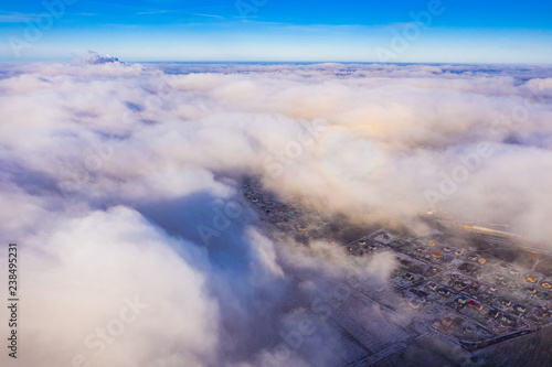 Fototapeta Naklejka Na Ścianę i Meble -  White clouds flying over rural area. Aerial landscape